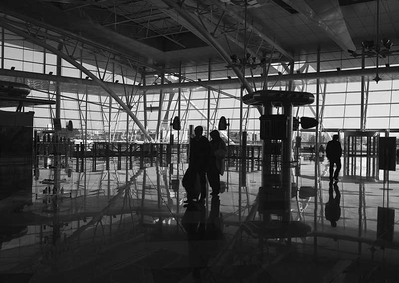 Travellers walking through an airport terminal